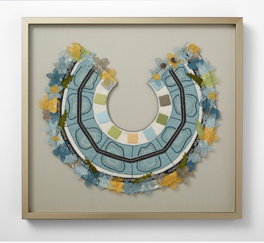 Artist's design of a "floral collar" inspired by work on wetlands restoration using stitched thread and textiles on linen fabric.