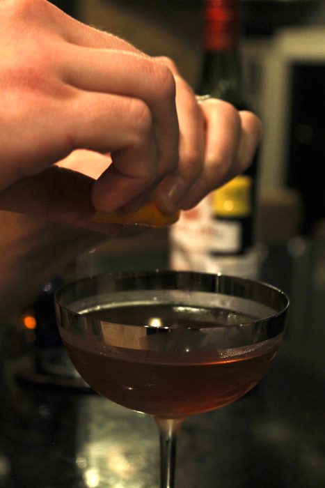 squeezing orange peel oil manhattan drink alcohol cocktail (c) Ben Marcus