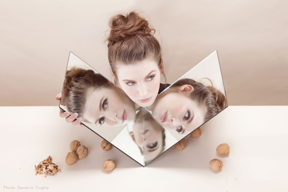 Jeanette Andrews with face reflected in mirrors